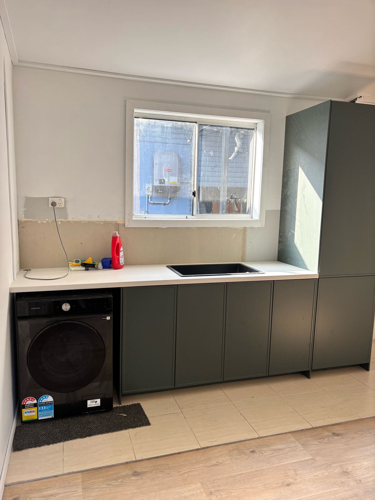 IKEA laundry fit-out with green cabinetry